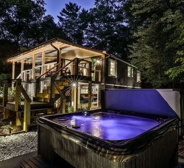 A hot tub in the middle of a yard.