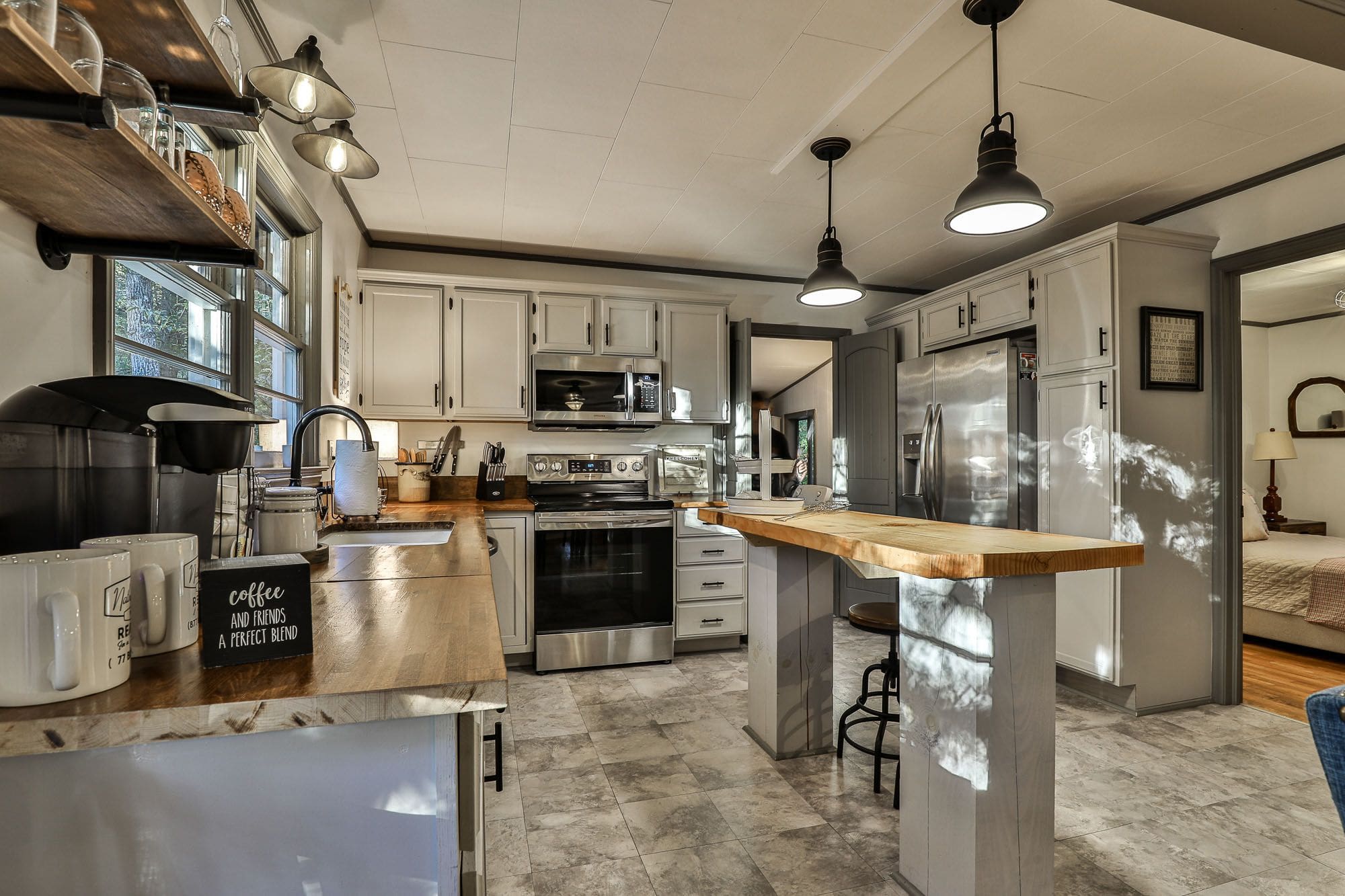 A kitchen with a large island and stainless steel appliances.