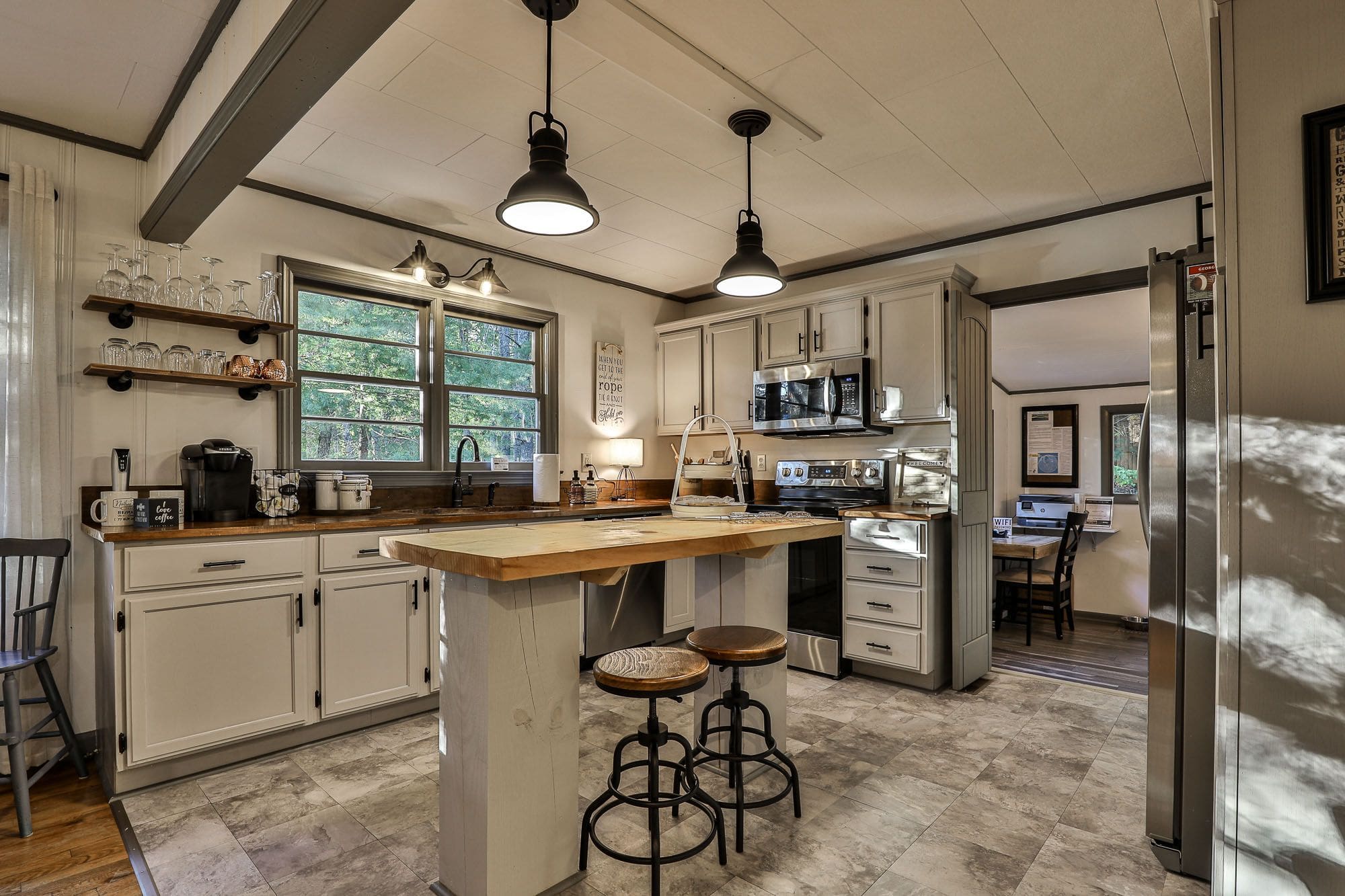 A kitchen with a bar and stools in it