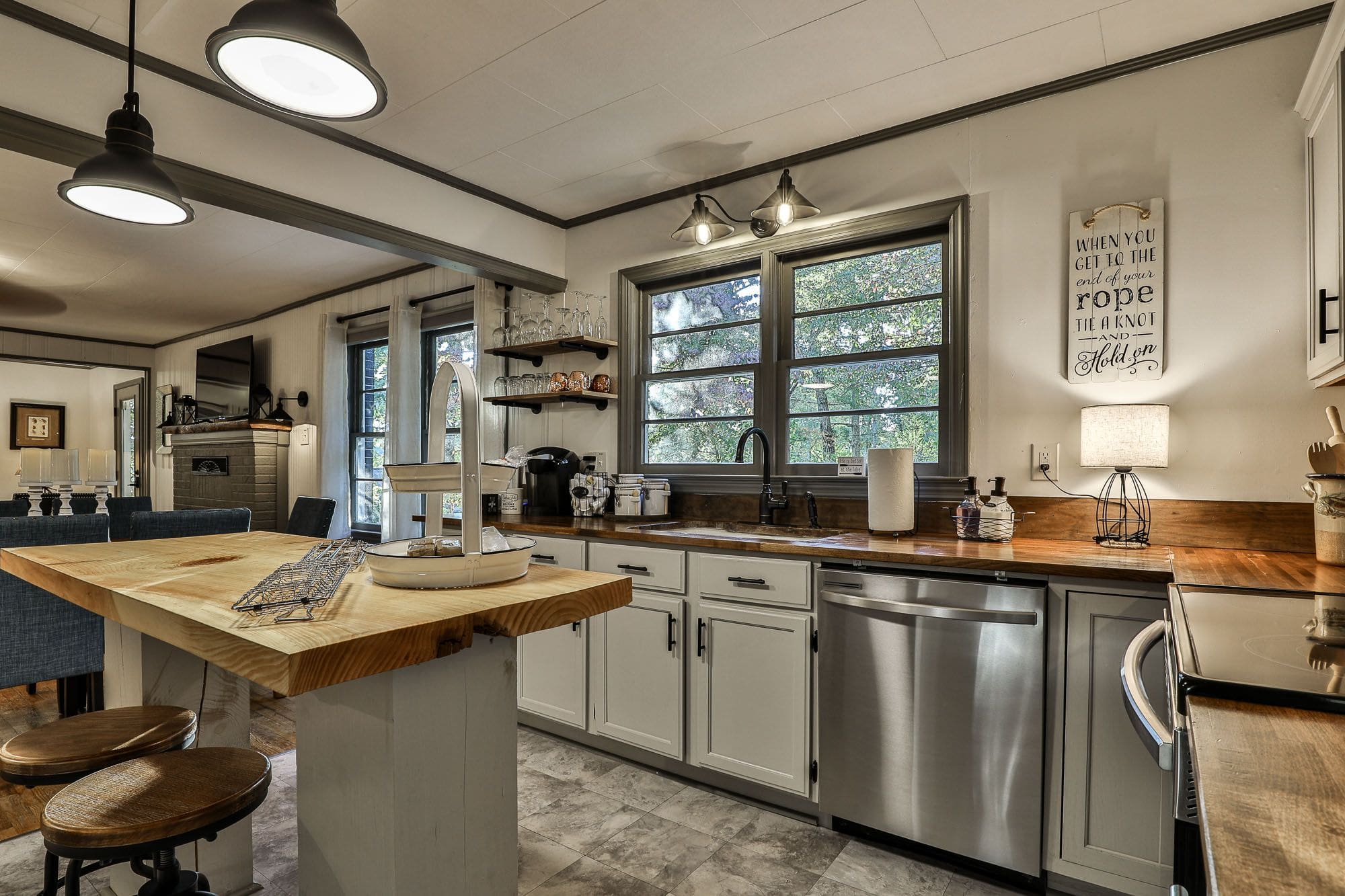 A kitchen with stainless steel appliances and wooden counters.