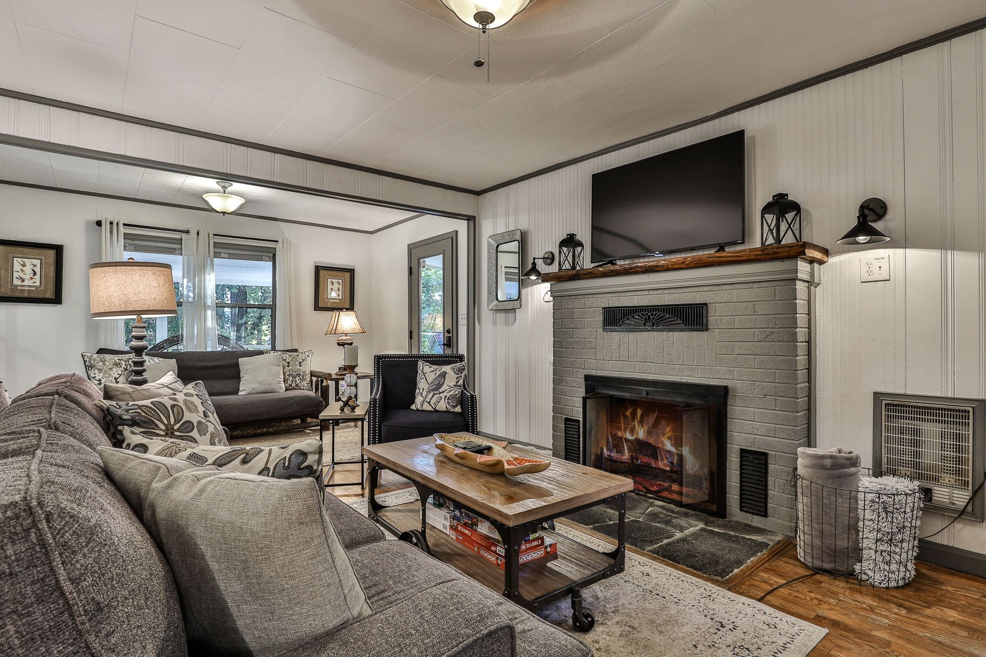 A living room with couches, coffee table and fireplace.