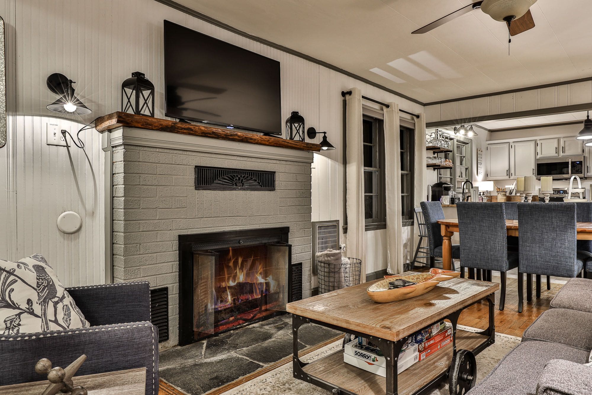 A living room with a fireplace and a tv.