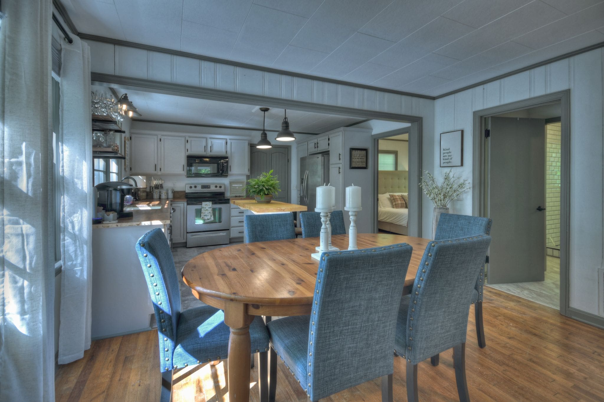 A dining room table with blue chairs in the middle of it.