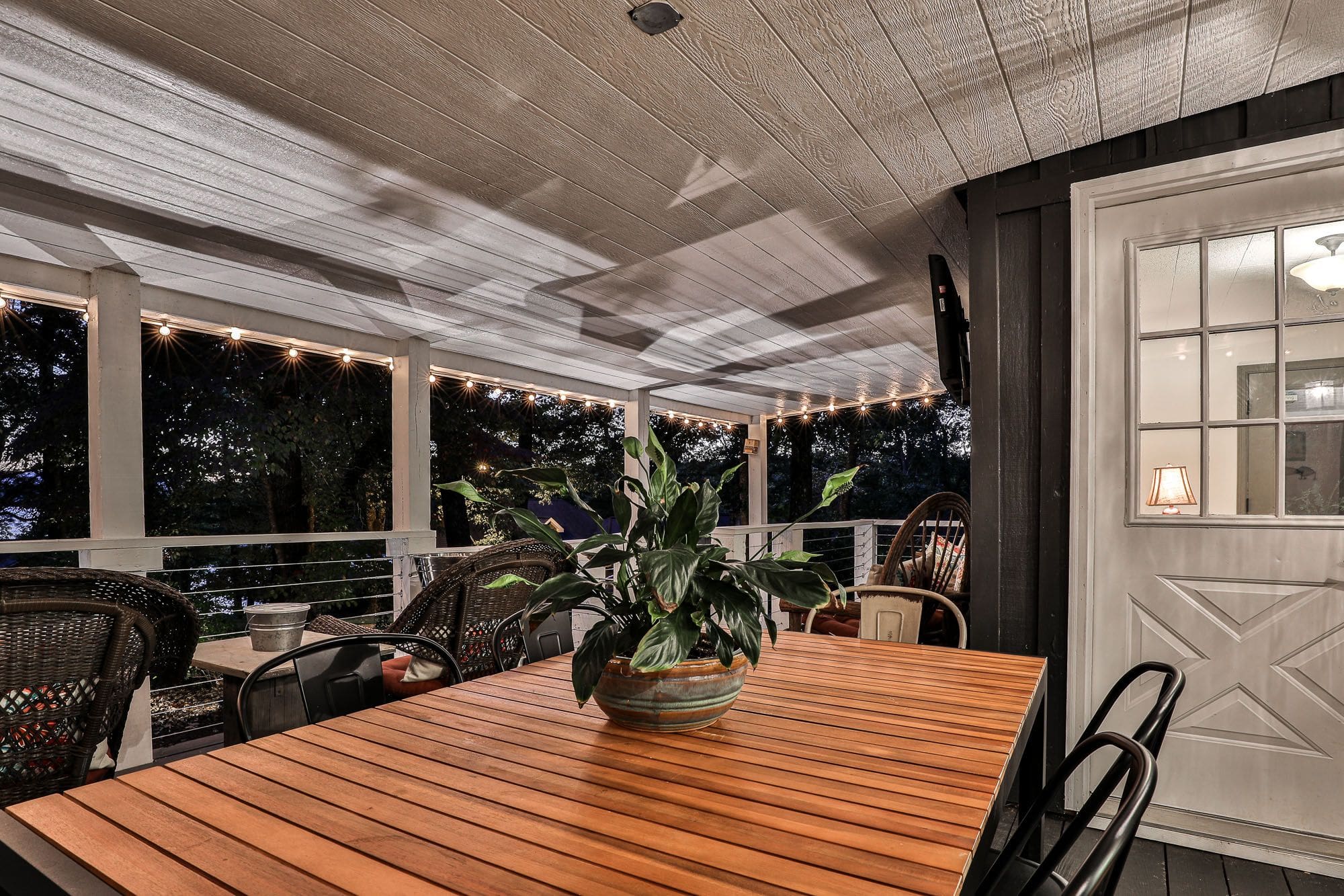 A table with a plant on it in the middle of an outdoor area.